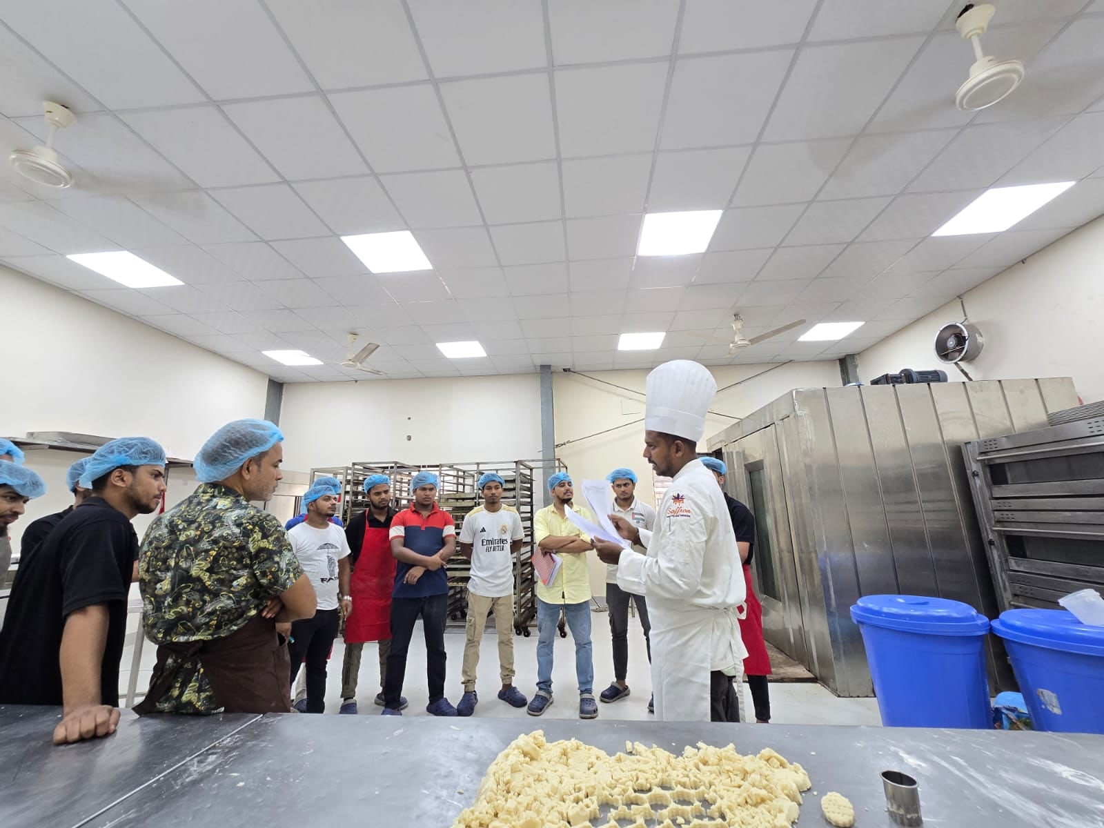 Chef Munna working with a kitchen team in a production setting