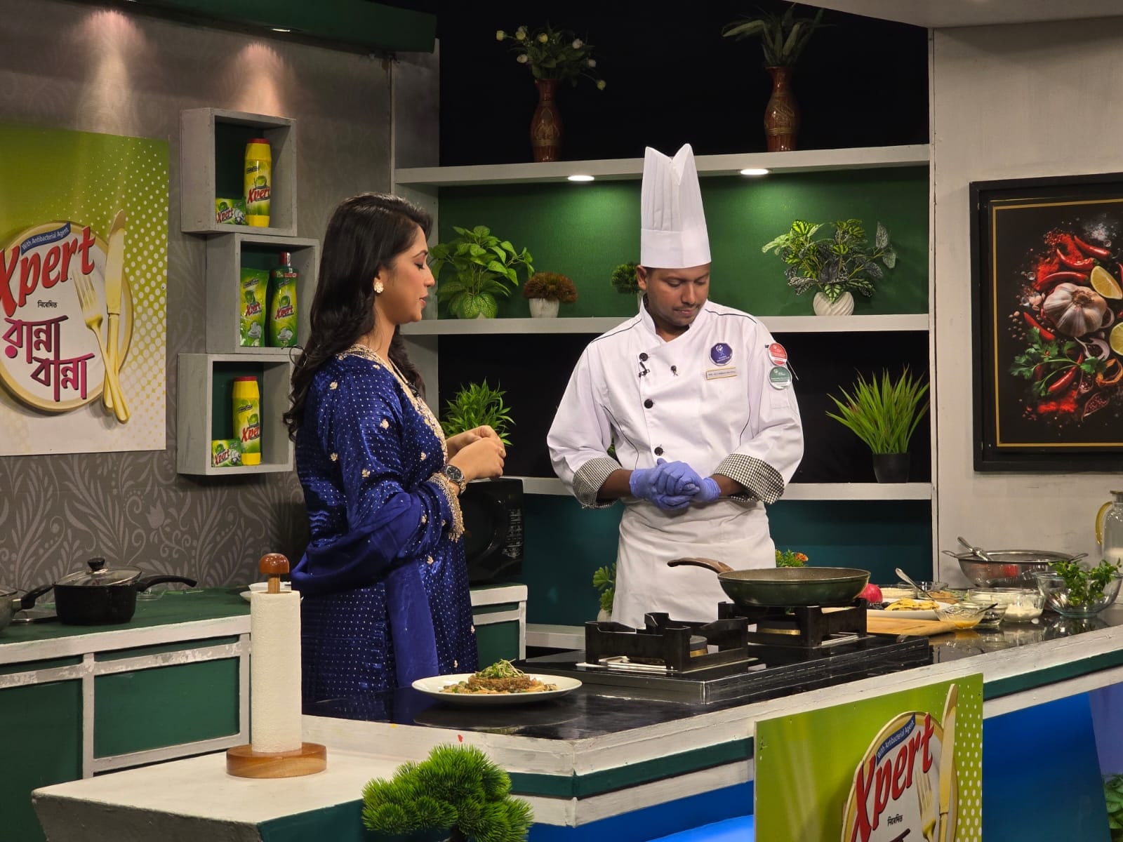 Chef Munna presenting food during a televised or studio cooking demonstration
