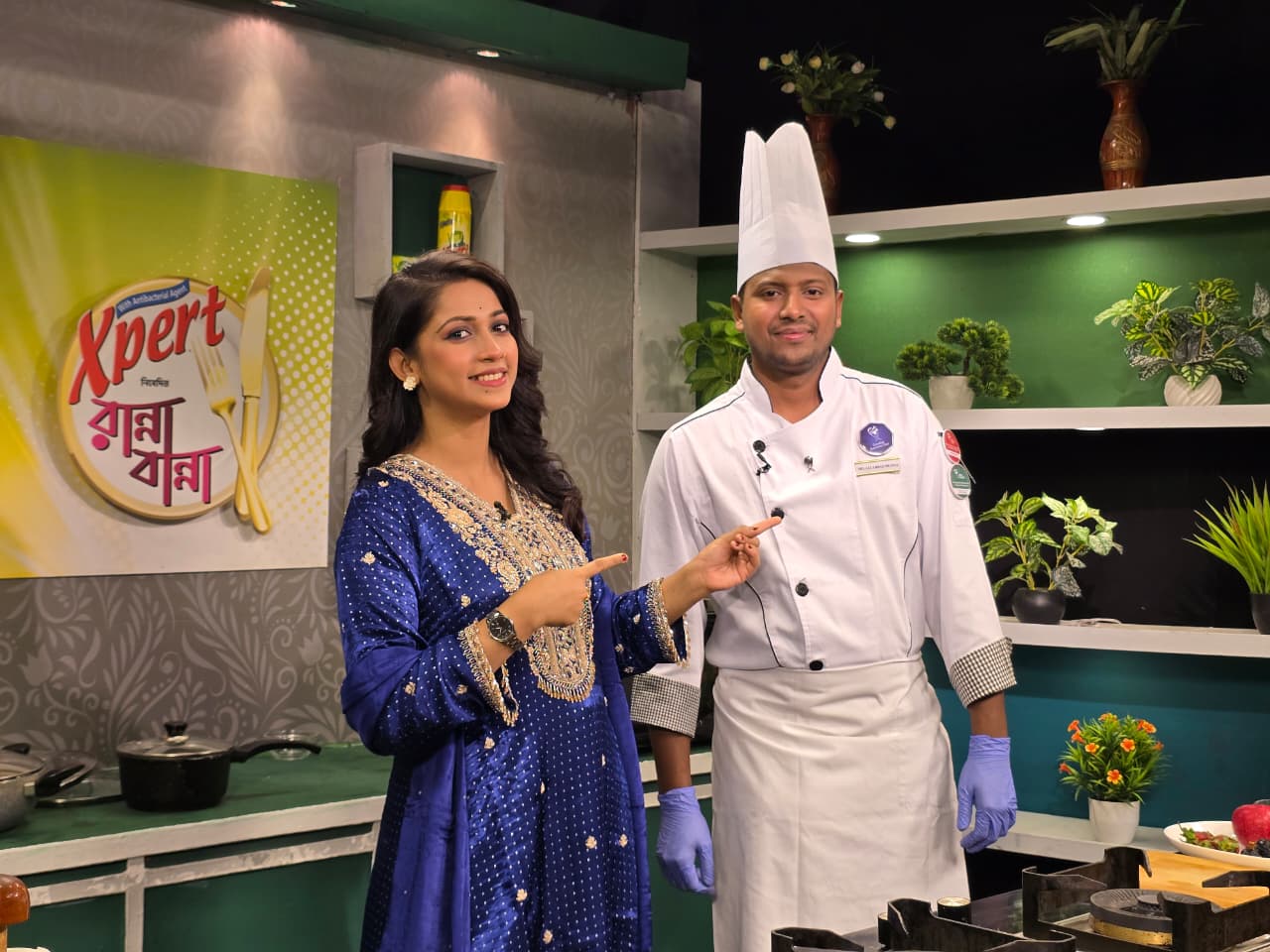 Chef Munna standing beside a television host during a studio cooking appearance