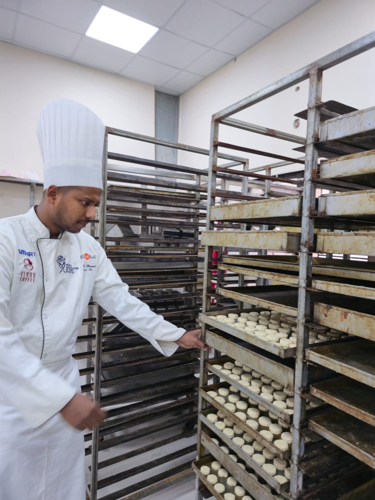 Chef Munna supervising production trays in a training kitchen environment