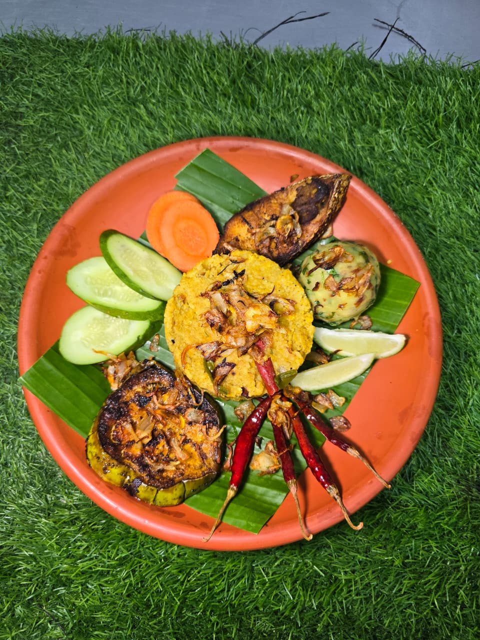 A traditional plated specialty served on an orange plate with charred vegetables and garnishes